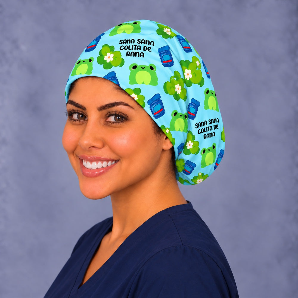 Three-quarter angle of a smiling nurse in a frog scrub cap, with frogs, white flowers and lettering shown at true print scale along the band