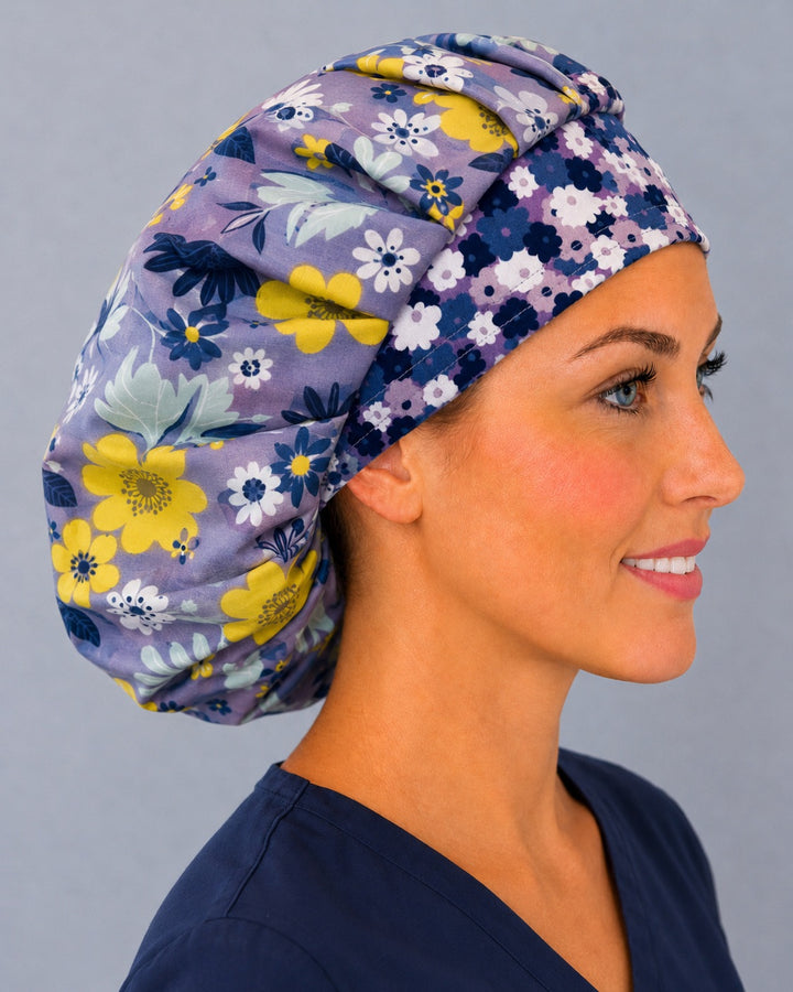 Right side profile of the lavender and yellow floral bouffant surgical hat — navy daisy contrast band, roomy breathable cotton cap for nurses