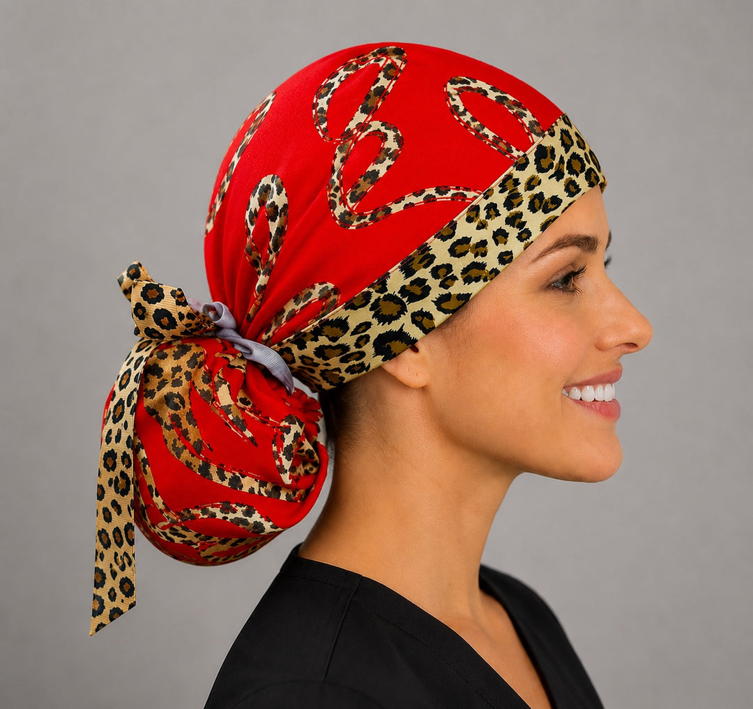 Leopard print hearts ponytail scrub cap right side profile showing gathered ponytail pouch of leopard hearts on red with leopard-print band and animal-print ribbon bow