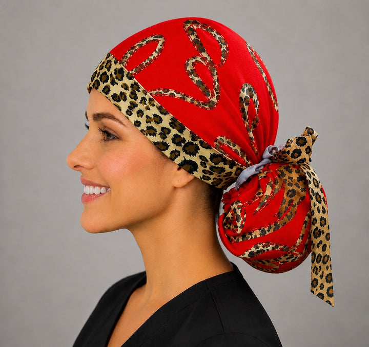 Leopard print hearts ponytail scrub cap right side profile with full ponytail pouch of leopard hearts on red and long animal-print ribbon ties