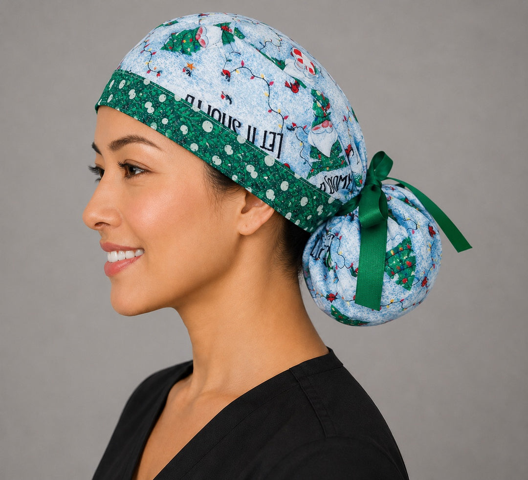 Let it Snome Christmas gnomes ponytail surgical cap right three-quarter angle showing tree-gnomes and Let It Snome text on sky blue with green snowball band and green ribbon bow