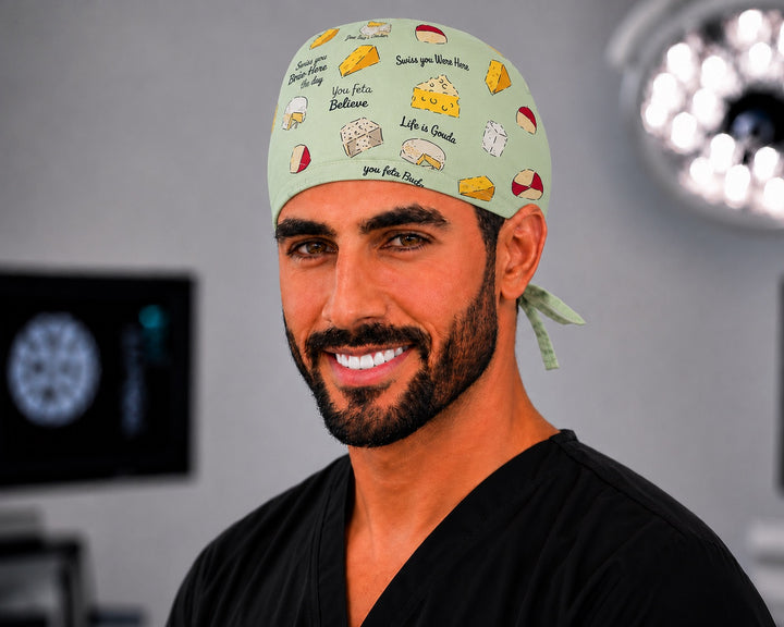 Male nurse wearing Life is Gouda funny cheese scrub cap for men, front angled view in the OR