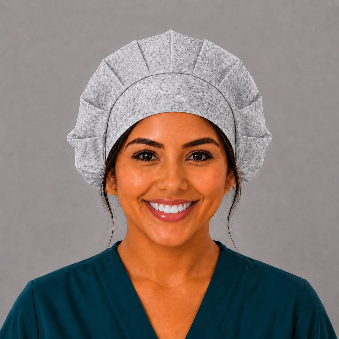 Woman wearing a light gray floral bouffant scrub cap, front view — soft neutral flower print, adjustable women&