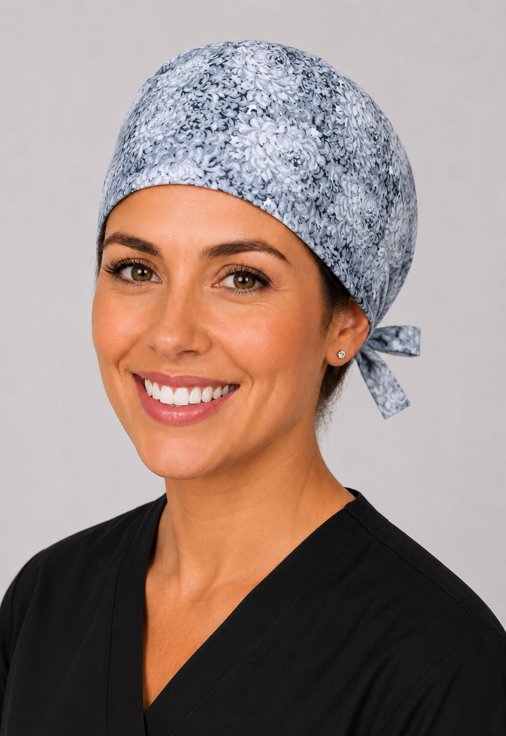 Three-quarter view of light gray flower scrub cap, unisex soft neutral adjustable surgical hat for nurses and surgical techs