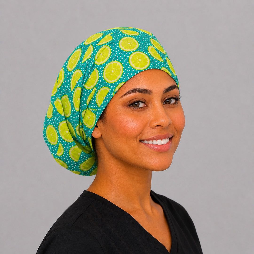 Angled view of lime citrus Euro scrub cap with bright lime slices on teal — handmade in USA adjustable surgical hat for OR nurses, techs, and vets.