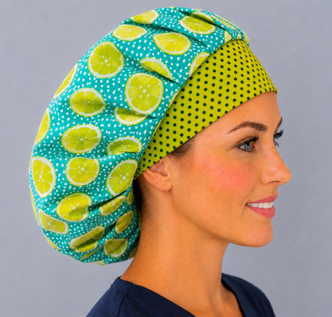 Side view of the lemon lime slice bouffant surgical cap — teal citrus print with green polka-dot band, breathable cotton cap for nurses