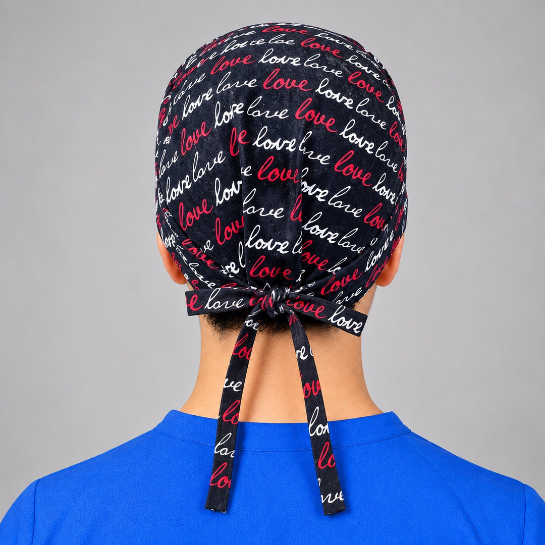 Rear knot with long tails on love lettering scrub hat, unisex fit shown on a man from behind