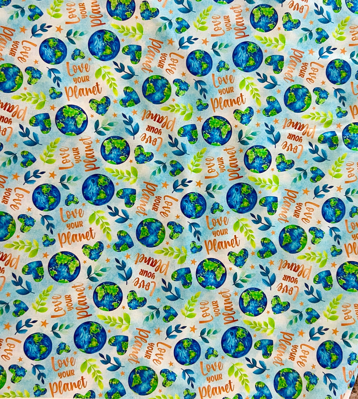 Love Your Planet fabric print swatch, watercolor Earth globes, green sprigs, and Love Your Planet lettering for OR World handmade scrub caps.