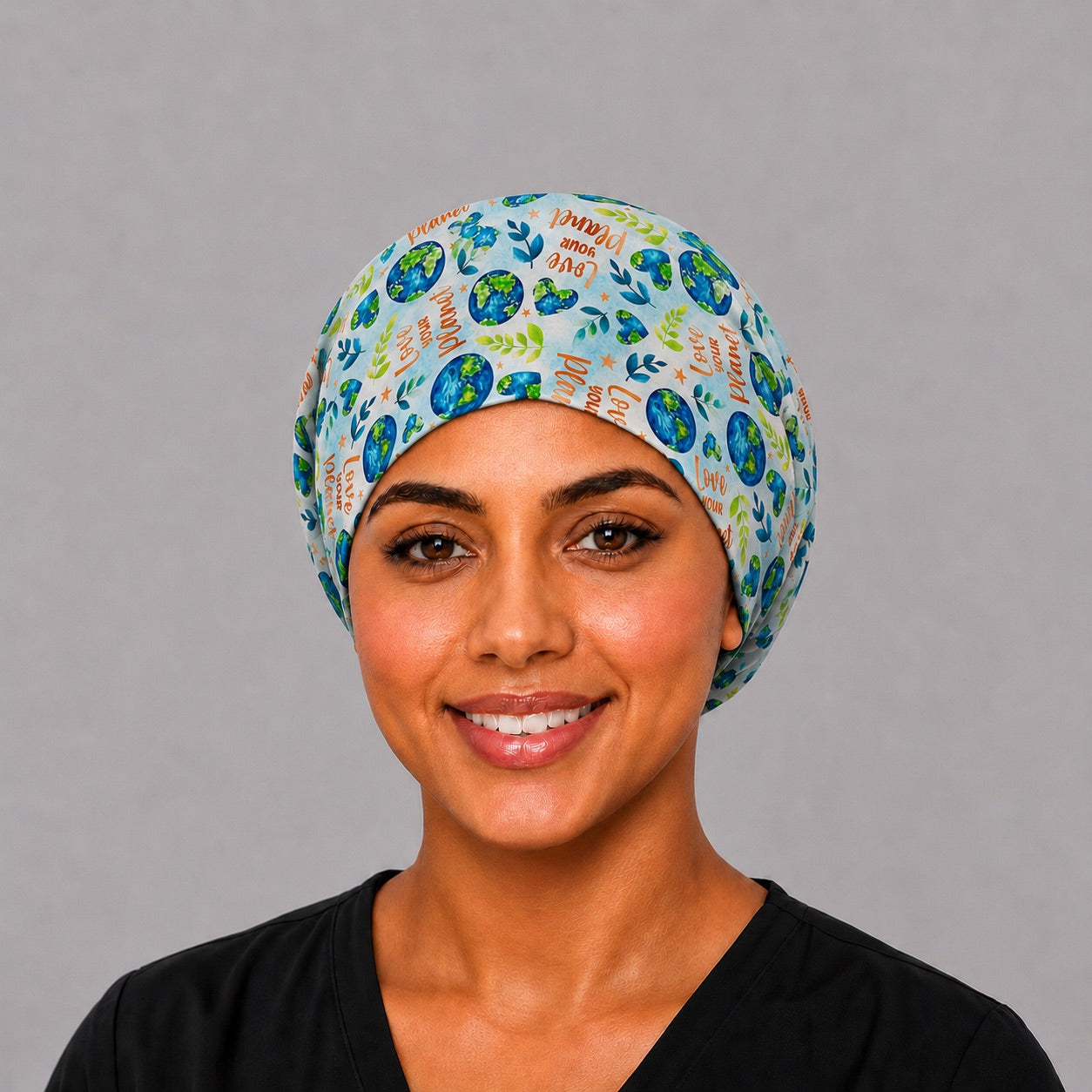Love Your Planet Euro scrub cap with watercolor Earth globes and Love Your Planet script, front view on a model, handmade in USA surgical hat for women from OR World.