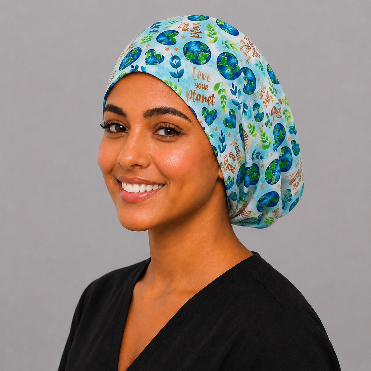 Love Your Planet Earth Day Euro scrub cap, three quarter view on a model, adjustable handmade USA surgical hat for women and OR nurses.