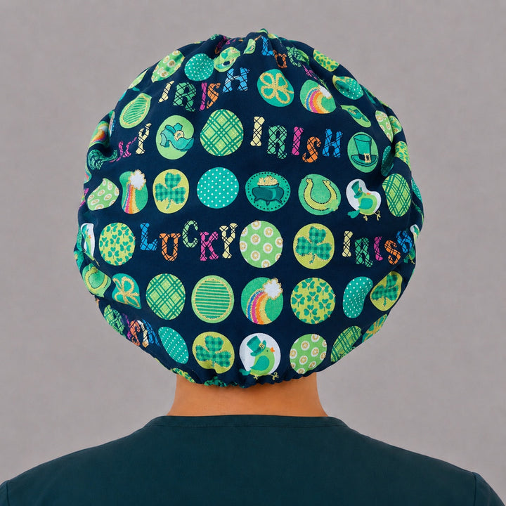 Back view of the Lucky shamrock bouffant scrub cap — full gathered fit showing pots of gold, horseshoes and IRISH lettering on navy
