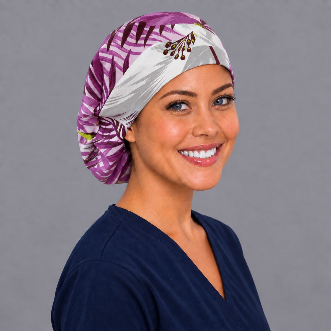 Magenta tropical Euro scrub cap, left angled smiling view — vivid palm frond print for OR nurses and surgical techs