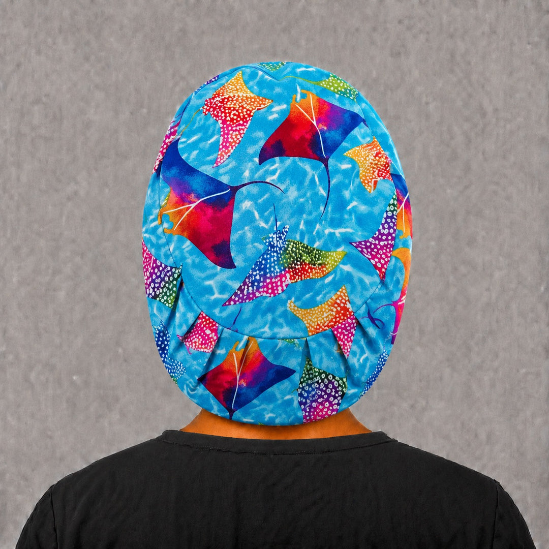 Back view of the manta ray Euro scrub cap — elastic gathered back showing colorful stingrays across the turquoise crown