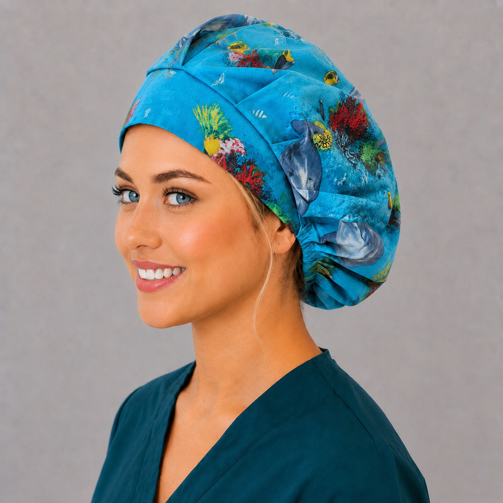 Marine dolphin bouffant surgical hat, three-quarter smiling view — underwater coral reef bouffant scrub cap for ocean lovers, breathable cotton