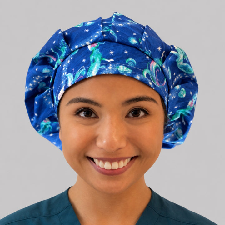 Mermaid ocean galaxy bouffant scrub cap for women, front view, glowing mermaids and stars on deep blue starry sea, handmade surgical hat by OR World