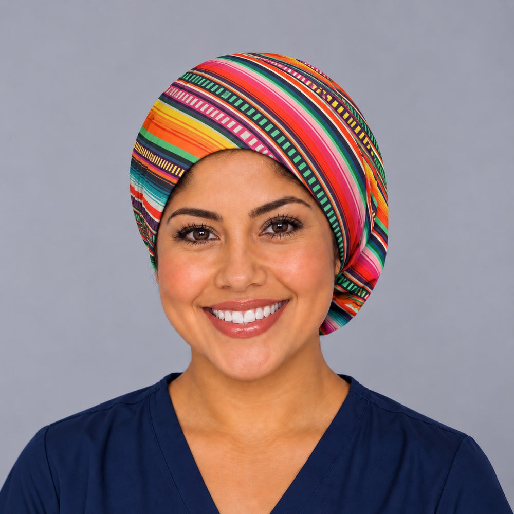 Nurse wearing a Mexican blanket bouffant surgical hat, front view, bright diagonal serape stripes