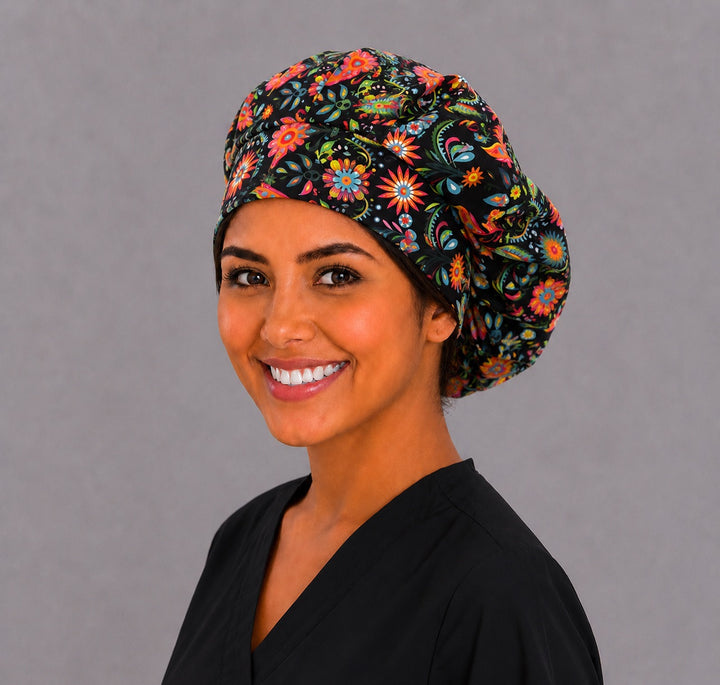 Mexican Talavera floral bouffant scrub cap for women on black, colorful surgical hat on Latina nurse, front view
