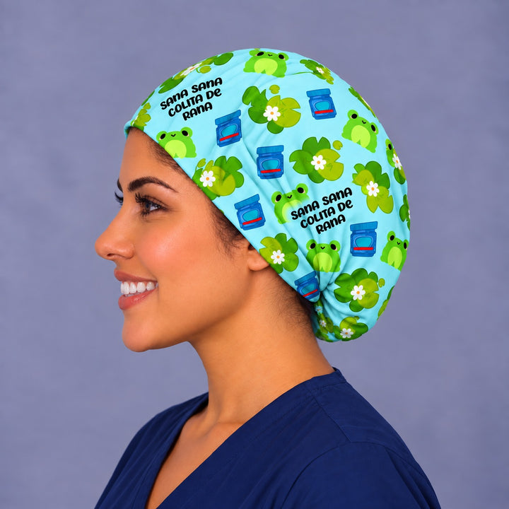 Side profile of a Mexican frog nurse hat, showing the little blue vapor rub jars and Sana Sana lettering across the deep euro crown