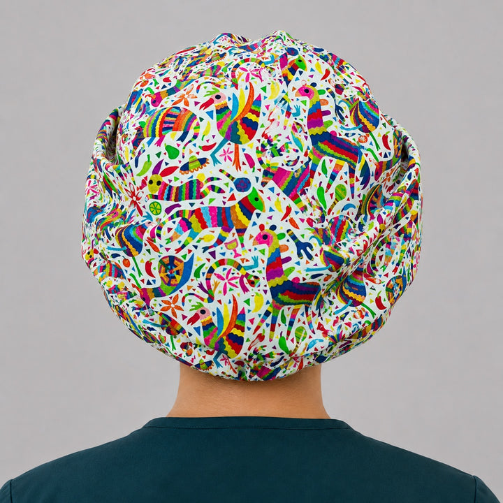 Mexican Otomí fiesta bouffant scrub cap for women, colorful Tenango folk-art surgical hat on Latina nurse, front view