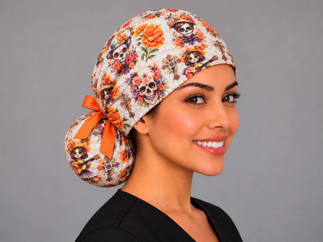 Over the shoulder view of the Mexican ponytail scrub cap showing the roomy hair pouch, guitar playing calaverita and skeleton dog in a painted hat