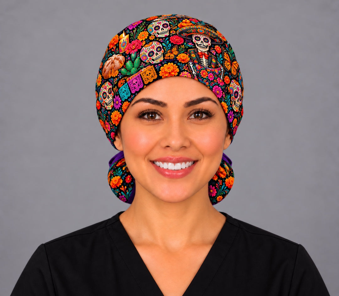 Front view of a Mexican ponytail surgical hat with a charro calavera, sugar skulls and papel picado across the forehead band