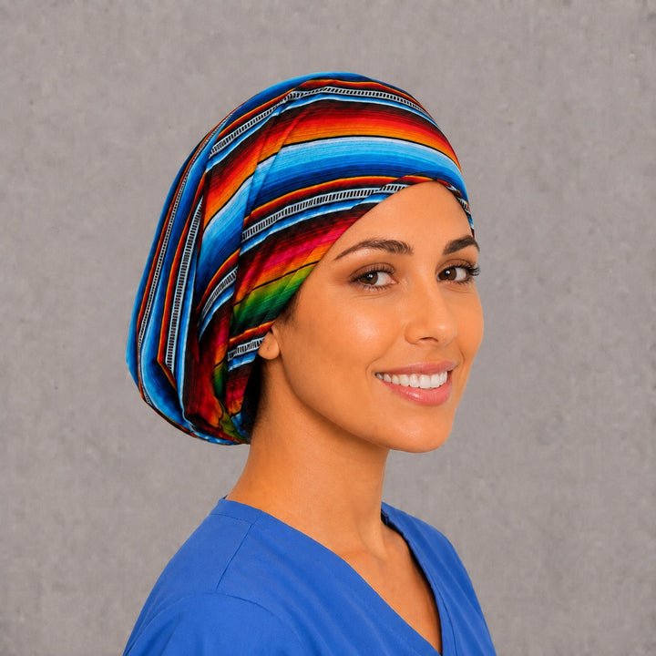 Back view of the Mexican serape Euro scrub cap — full gathered coverage showing rainbow sarape stripes across the crown