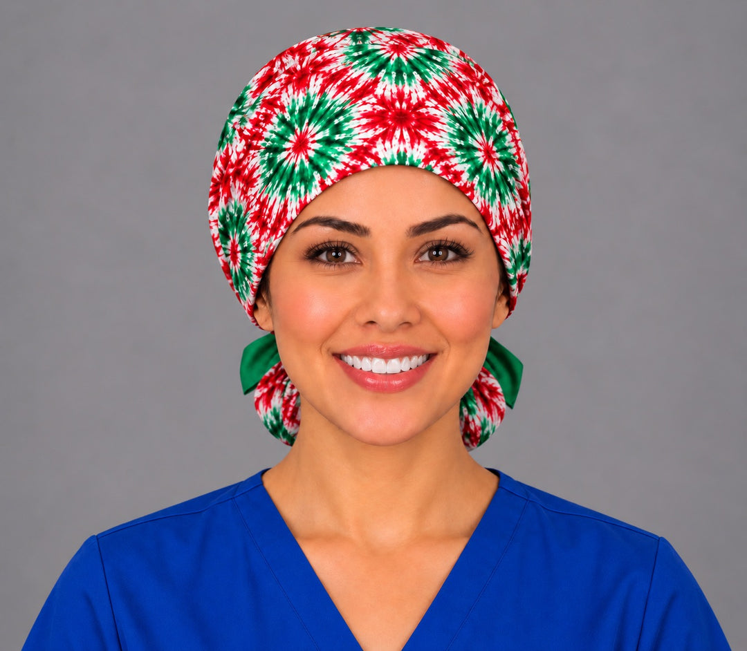 Nurse wearing a Mexican tie-dye ponytail surgical hat, front view, red and green mandala starbursts on white