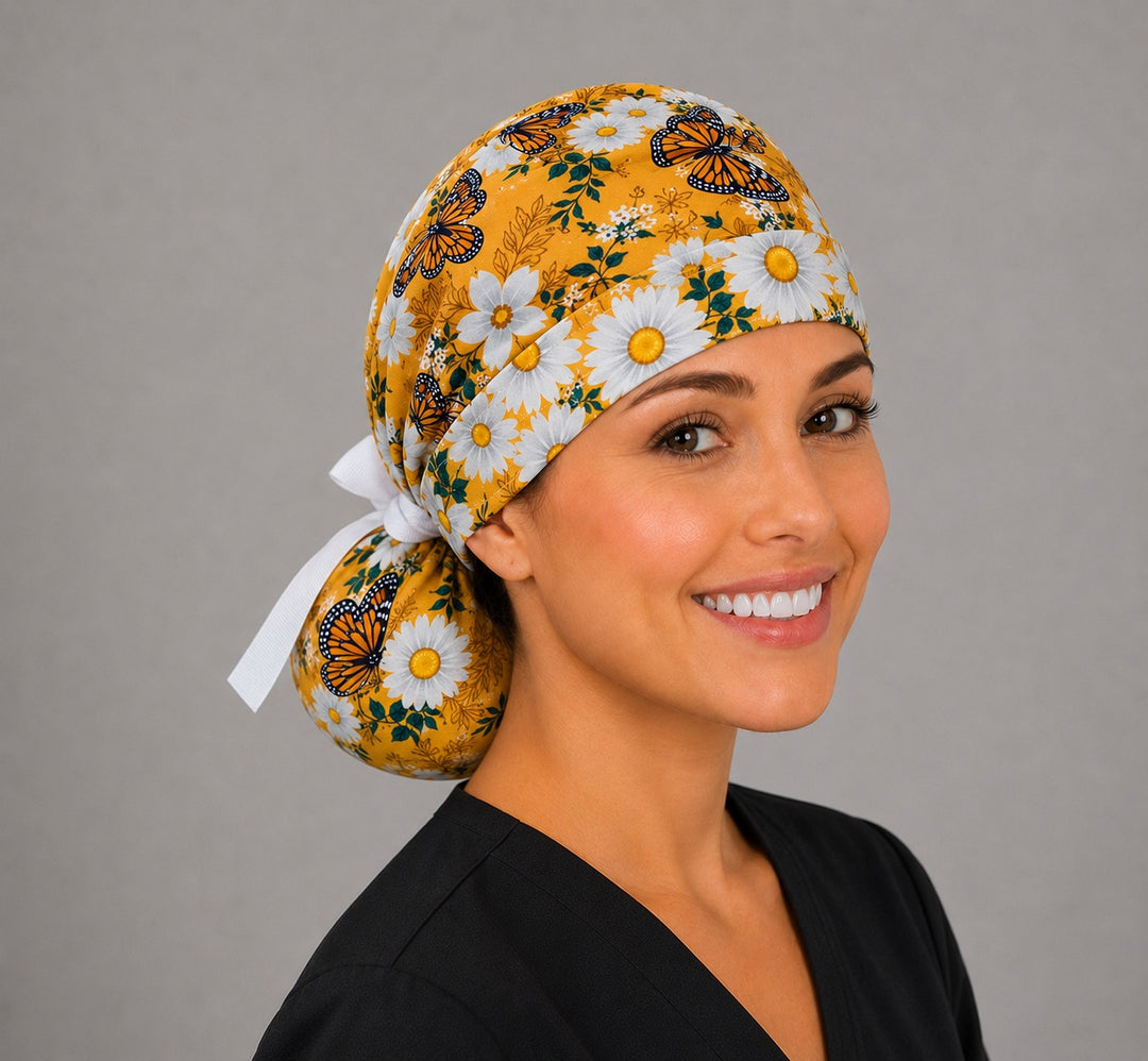 Monarch butterfly daisy ponytail scrub cap left side profile with full ponytail pouch of monarchs and white daisies and long white ribbon ties