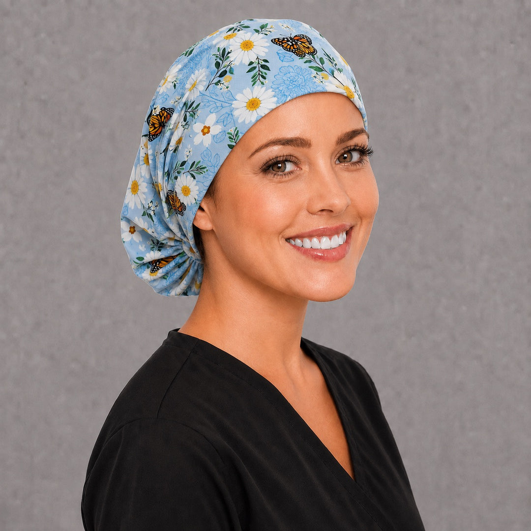 Monarch and daisy Euro scrub cap, right angled smiling view — blue floral print for surgical techs and L&D nurses