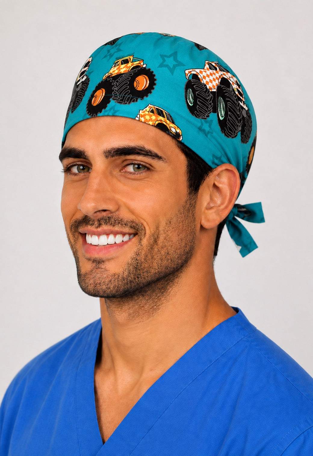 Three-quarter view of monster truck unisex teal pediatric adjustable surgical hat for nurses and surgical techs