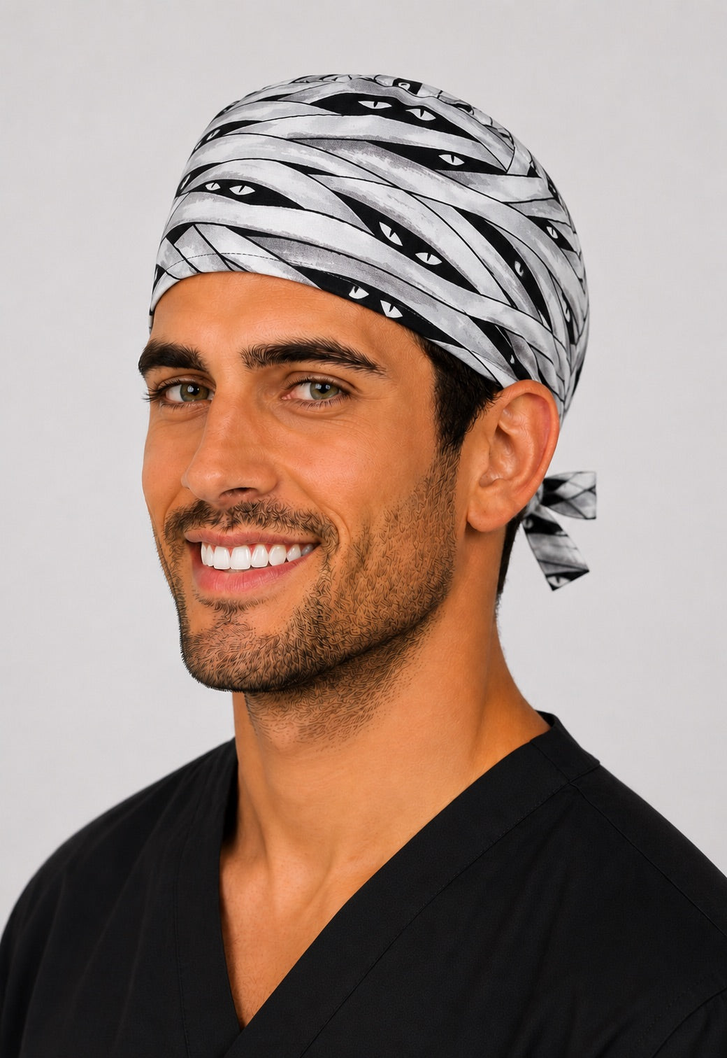 Left profile of Halloween mummy bandage men's scrub cap, adjustable tie-back spooky surgical hat for surgeons and techs