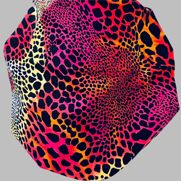 Close-up of neon cheetah leopard fabric in pink, orange, yellow &amp; black — handmade-in-USA OR World bouffant surgical hat.