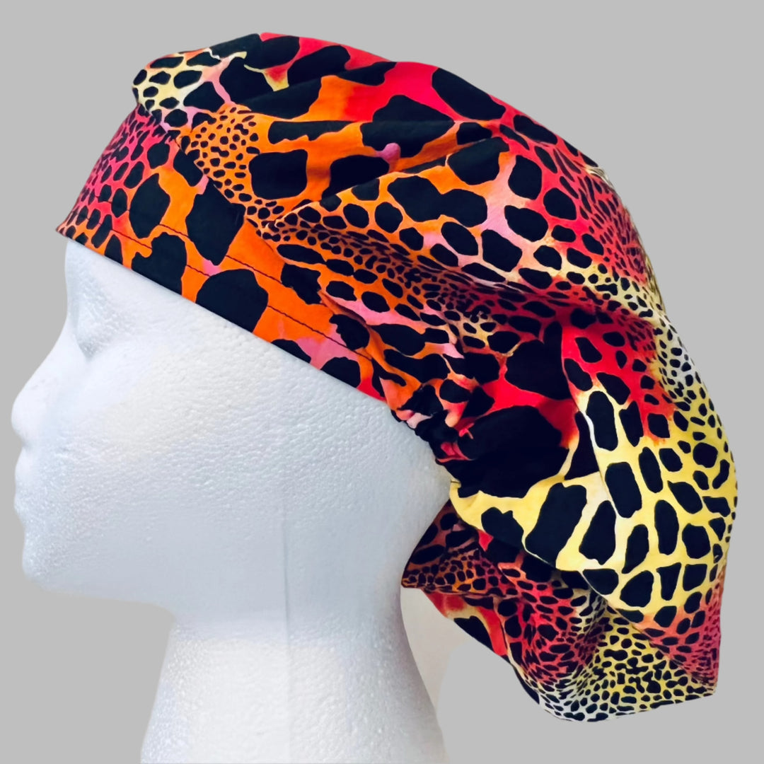 Side view of neon leopard bouffant scrub cap with orworld.net label — handmade-in-USA surgical hat, fun gift for nurses &amp; surgeons.