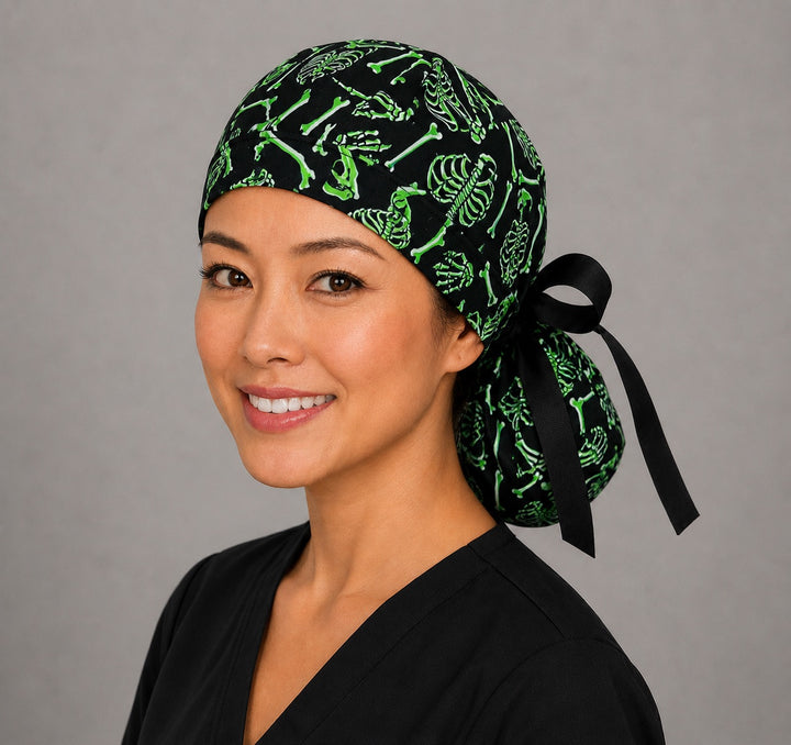 Neon green skeleton ponytail nurse cap front three-quarter angle on smiling model showing skulls, ribcages and crossed bones on black