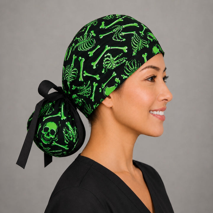 Neon green skeleton ponytail scrub cap right side profile showing green skull and crossbones pouch and long black ribbon ties