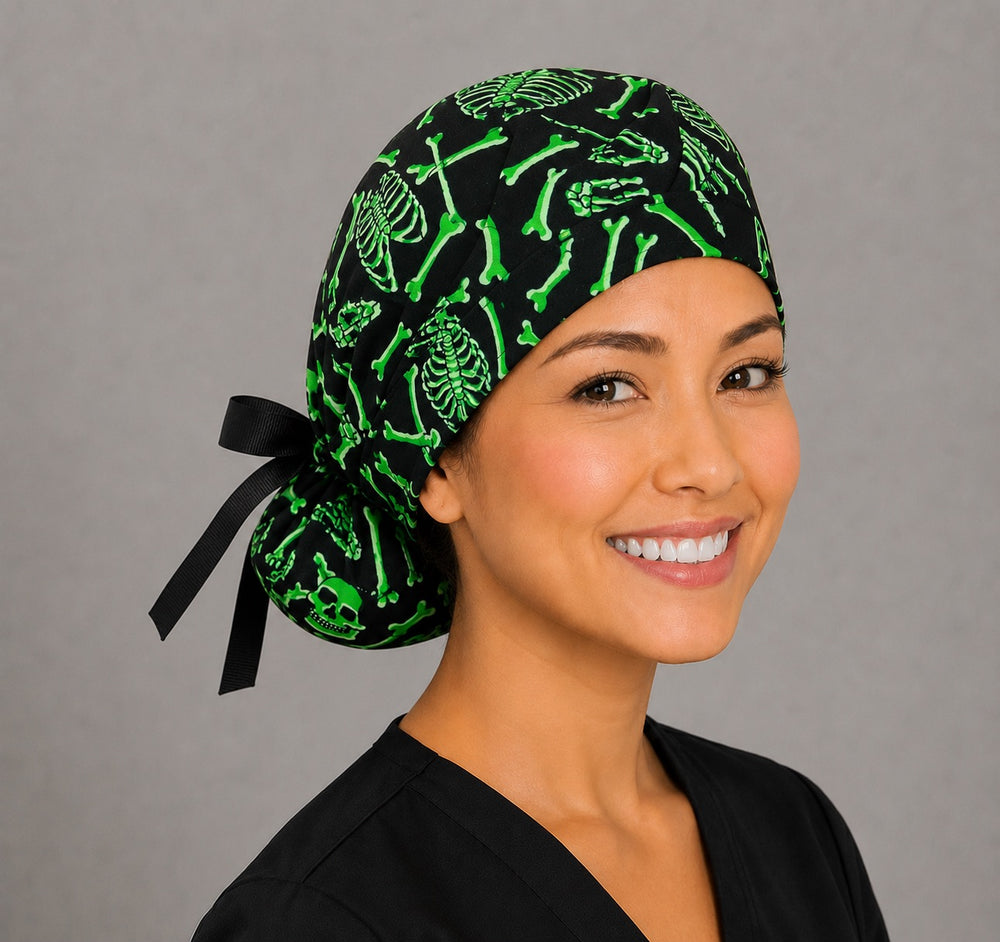Neon green skeleton ponytail surgical cap right three-quarter angle showing gathered ponytail pouch of green skulls and bones with black ribbon