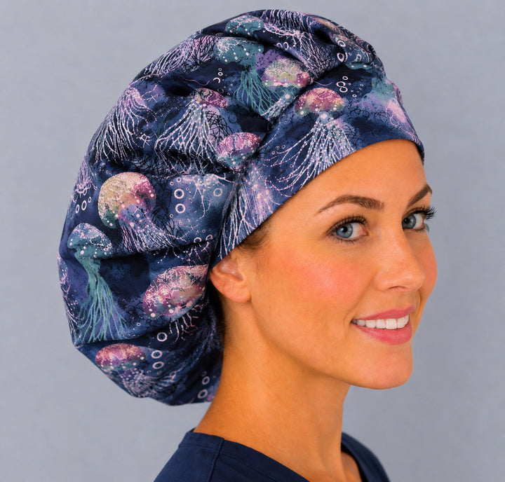 Neon jellyfish bouffant cap for women, right angled smiling view — handmade coastal marine surgical cap, USA made