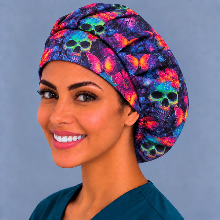 Neon skull bouffant scrub cap, right angled smiling view — pink butterfly and flower print for OR nurses and surgical techs