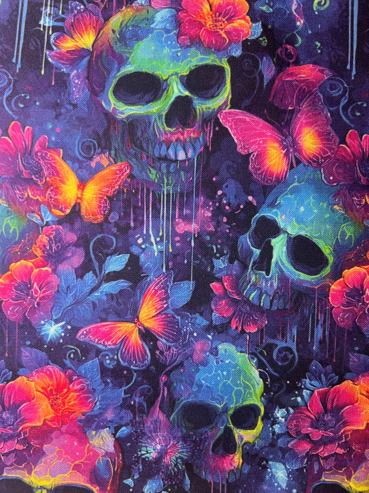 Fabric detail of the Neon Skull &amp; Butterfly scrub cap — close-up of dripping neon skulls, butterflies and flowers on indigo cotton