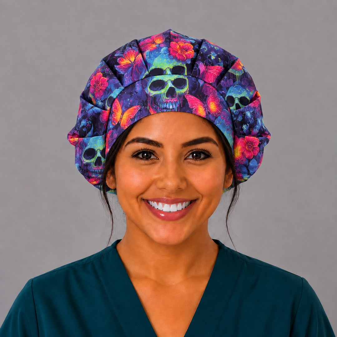 Woman wearing a Neon Skull &amp; Flower bouffant scrub cap, front smiling view — neon green skulls and pink flowers, roomy gathered surgical hat