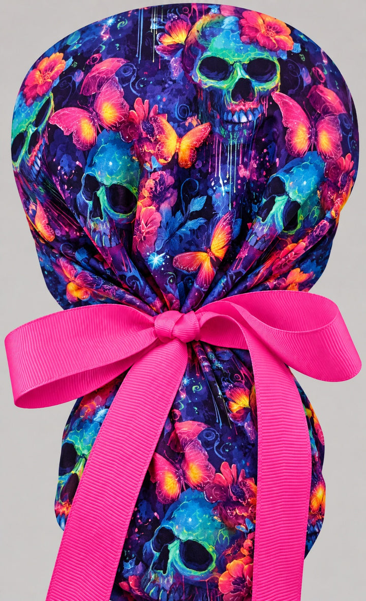 Back of the neon skull ponytail scrub cap showing the adjustable hot pink grosgrain bow tie