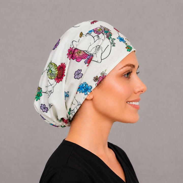 Right side profile of the newborn baby floral Euro surgical hat — peony and daisy print, breathable cotton cap for OB nurses