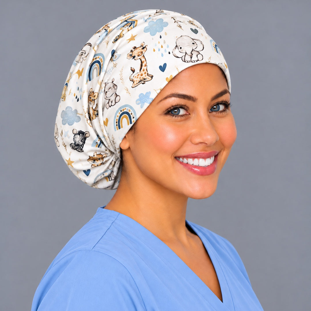 Right three-quarter angle of a NICU nurse scrub hat, showing boho rainbows and rain clouds across the crown and the adjustable elastic gather at the nape