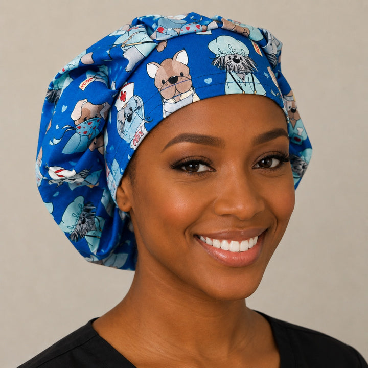 Nurse dog print bouffant scrub cap right three-quarter angle on smiling model showing puppies dressed as nurses and doctors on blue, OR World veterinary nurse hat