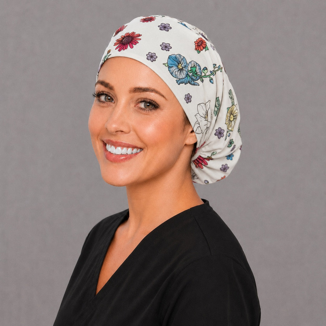 OB nurse floral baby Euro cap, left angled smiling view — handmade newborn and blossom surgical cap, USA made