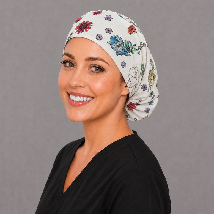 OB nurse floral baby Euro cap, left angled smiling view — handmade newborn and blossom surgical cap, USA made