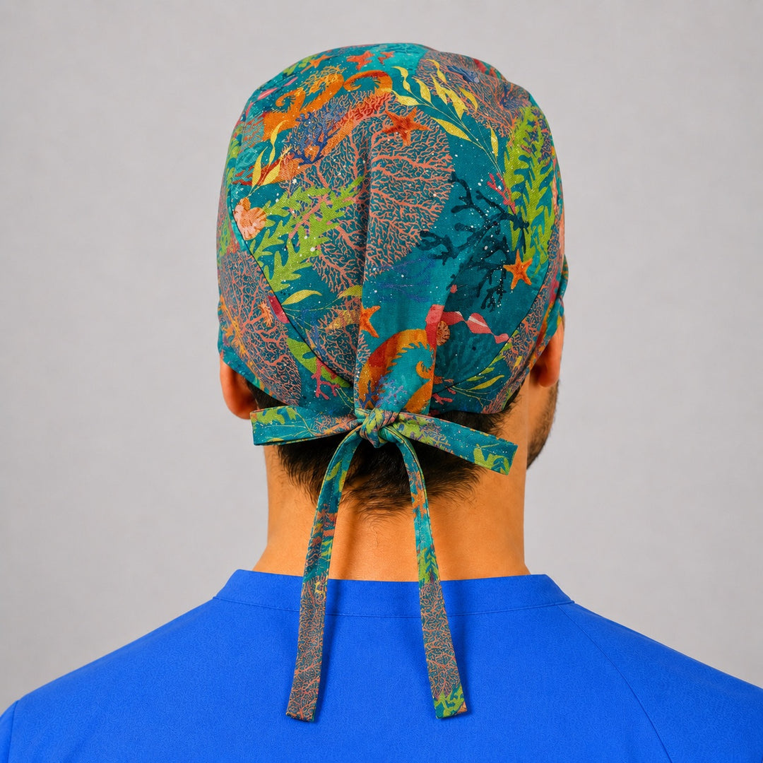 Back view of ocean coral reef tie back scrub cap showing the adjustable bow, colorful coral kelp starfish and seahorse marine print, unisex surgical hat handmade in USA by OR World.