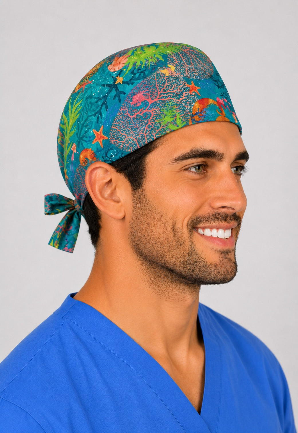 Side profile of ocean coral reef tie back scrub cap on a male model, colorful sea life surgical hat for OR nurses and surgeons, handmade in USA by OR World.