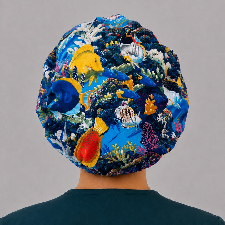 Back view of the ocean fish bouffant scrub cap — full gathered coverage showing pufferfish, butterflyfish and coral across the crown