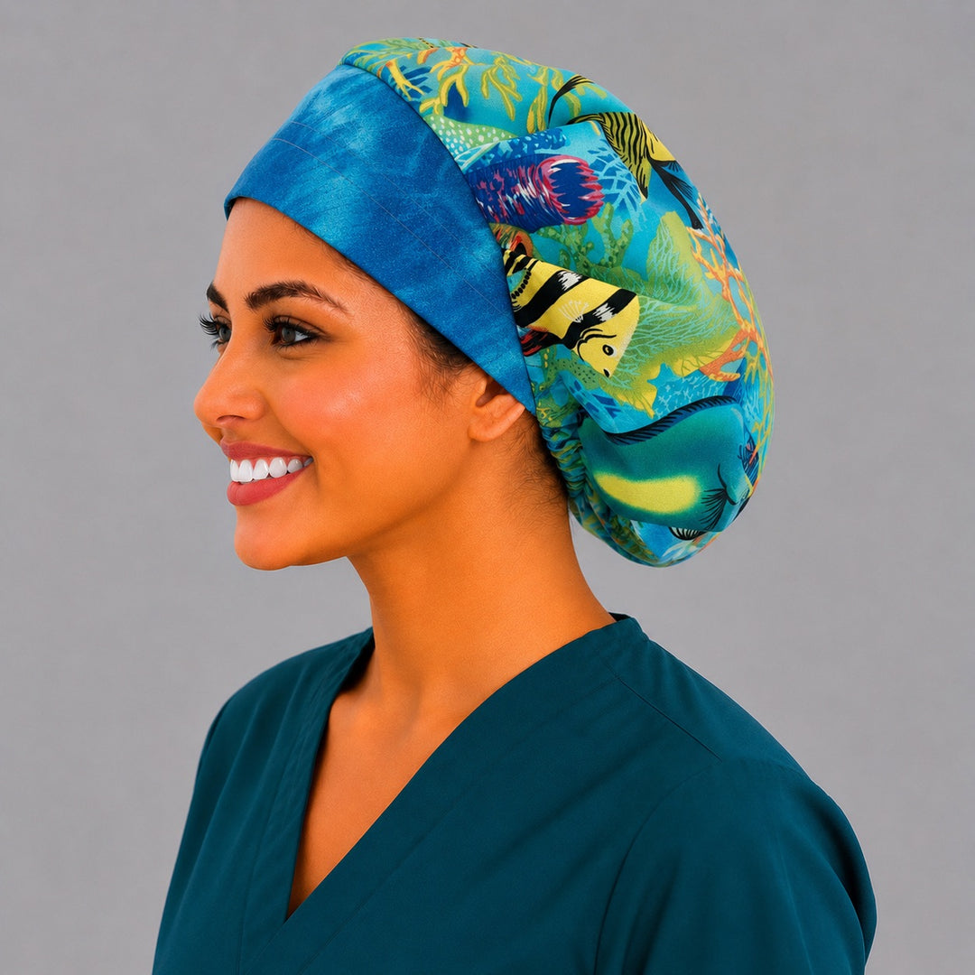 Ocean sea turtle bouffant scrub cap angled view on a smiling vet tech — coral reef fish print roomy cap that secures long thick hair